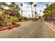 Gated community entrance with mature trees and desert landscaping at 4391 Gannet Cir # 16, Las Vegas, NV 89103
