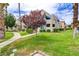 Multi-level condo building with landscaped green space, mature trees, and walkways at 4391 Gannet Cir # 16, Las Vegas, NV 89103
