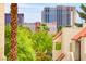 View of condos with red tile roofs, palm trees, and the Treasure Island Casino in the background at 4391 Gannet Cir # 16, Las Vegas, NV 89103