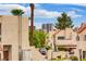 Condos with red tile roofs, desert landscaping, and views of the Las Vegas skyline at 4391 Gannet Cir # 16, Las Vegas, NV 89103