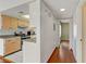 Galley kitchen boasts stainless steel appliances, tile floors, and wood cabinets at 4391 Gannet Cir # 16, Las Vegas, NV 89103