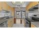Kitchen area with stainless steel appliances, wood cabinets, and sliding glass doors at 4391 Gannet Cir # 16, Las Vegas, NV 89103
