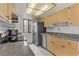 Kitchen featuring stainless steel appliances, tile floors, and wood cabinets at 4391 Gannet Cir # 16, Las Vegas, NV 89103