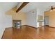 Open living room features hardwood flooring, a brick fireplace, and light-filled windows at 4391 Gannet Cir # 16, Las Vegas, NV 89103