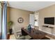Virtually staged office area features a desk, chair, and view to kitchen at 4391 Gannet Cir # 16, Las Vegas, NV 89103