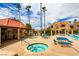 Community pool area with jacuzzi, picnic tables, lounge chairs, and desert landscaping at 4391 Gannet Cir # 16, Las Vegas, NV 89103