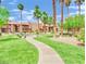 Well-maintained community grounds with walking path, lush greenery, and shaded seating areas at 4421 Alexis Dr # 429, Las Vegas, NV 89103