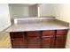 Granite bar top over dark wood cabinets in an open-concept kitchen at 4421 Alexis Dr # 429, Las Vegas, NV 89103