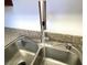 Stainless steel kitchen sink with modern, pull down faucet for easy cleaning at 4421 Alexis Dr # 429, Las Vegas, NV 89103