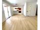 Spacious living room with light wood floors, sliding glass doors, and view into kitchen at 4421 Alexis Dr # 429, Las Vegas, NV 89103