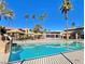 Clear community pool surrounded by tropical palm trees and cabanas creating a serene and vacation-like atmosphere at 4421 Alexis Dr # 429, Las Vegas, NV 89103