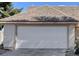 Home's white garage door offering secure parking and additional storage space at 4726 Castle Rock Ct, Las Vegas, NV 89147