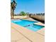 Refreshing pool with a tanning ledge set within a private backyard oasis at 4726 Castle Rock Ct, Las Vegas, NV 89147