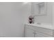 Bathroom vanity with a bouquet of flowers and toiletries atop a white vanity at 4739 Glenndavis Dr, Las Vegas, NV 89121