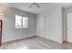Bedroom showcasing a closet, a window, and laminate floors at 4739 Glenndavis Dr, Las Vegas, NV 89121
