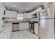 Well-lit kitchen featuring white cabinets, granite countertops, and stainless steel appliances at 4739 Glenndavis Dr, Las Vegas, NV 89121