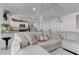 Bright living room with large sectional sofa and open floor plan to the kitchen at 4739 Glenndavis Dr, Las Vegas, NV 89121