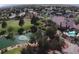 Aerial view of a community clubhouse, pool, and golf course at 4833 Lawnwood Ct, Las Vegas, NV 89130