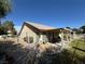 Spacious backyard with a covered patio, grass, and partial fence, perfect for outdoor living and entertaining at 4833 Lawnwood Ct, Las Vegas, NV 89130