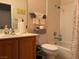 Standard bathroom with shower-tub combination, tiled walls, and vanity with storage, practical and functional at 4833 Lawnwood Ct, Las Vegas, NV 89130
