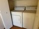 Efficient laundry area with a side-by-side washer and dryer, and storage space at 4833 Lawnwood Ct, Las Vegas, NV 89130