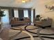 Inviting living room featuring plush seating, stylish rug, ample natural light, and modern décor at 4833 Lawnwood Ct, Las Vegas, NV 89130