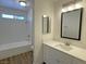 This is a bathroom with tile floors, a white vanity and a bathtub at 5030 Salinaz Cir, Las Vegas, NV 89118