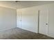 Neutral-toned bedroom, featuring soft carpeting and ample storage with two closet doors for convenience at 5030 Salinaz Cir, Las Vegas, NV 89118