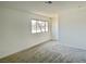 Carpeted bedroom featuring a window for natural light and neutral wall color at 5030 Salinaz Cir, Las Vegas, NV 89118