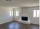 Bright living room with new laminate flooring and a brick fireplace at 5030 Salinaz Cir, Las Vegas, NV 89118
