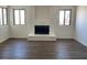 Bright living room with new laminate flooring and a brick fireplace at 5030 Salinaz Cir, Las Vegas, NV 89118