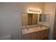 Bright bathroom featuring a double sink vanity with neutral countertops and a large mirror at 5125 W Reno Ave # 1059, Las Vegas, NV 89118