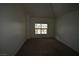 Naturally lit bedroom with soft brown carpet and a view of trees outside the window at 5125 W Reno Ave # 1059, Las Vegas, NV 89118