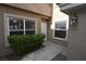 Exterior entrance of condo with shrubbery, cement path and view of door and windows at 5125 W Reno Ave # 1059, Las Vegas, NV 89118
