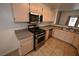 Modern kitchen with stainless steel appliances, granite counters, and warm-toned cabinets at 5125 W Reno Ave # 1059, Las Vegas, NV 89118