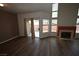 Inviting living room with hard wood floors, fireplace, and abundant natural light from windows and balcony door at 5125 W Reno Ave # 1059, Las Vegas, NV 89118