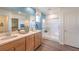 Well-lit bathroom with dual sinks, wood cabinets, a glass enclosed shower, and a walk-in closet at 551 Ruby Robin Ave # Lot 750, Henderson, NV 89011