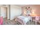 Charming bedroom featuring soft pink walls, matching desk, plush bedding, and decorative tennis rackets at 551 Ruby Robin Ave # Lot 750, Henderson, NV 89011