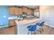 Well-lit kitchen features quartz countertops, an island with seating, and stainless steel appliances at 551 Ruby Robin Ave # Lot 750, Henderson, NV 89011