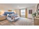Sun-drenched primary bedroom with ample space, carpet flooring, and stylish decor at 551 Ruby Robin Ave # Lot 750, Henderson, NV 89011