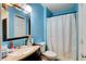 Bright blue bathroom featuring a vanity with sink, toilet and shower at 5900 Fawn Ave, Las Vegas, NV 89107