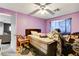 Bedroom with purple walls, unmade bed and poor housekeeping at 5900 Fawn Ave, Las Vegas, NV 89107