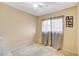 Bedroom features neutral walls, ceiling fan, window with curtains, and carpeted floors at 5900 Fawn Ave, Las Vegas, NV 89107