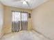Bedroom features neutral walls, ceiling fan, window with curtains, and carpeted floors at 5900 Fawn Ave, Las Vegas, NV 89107