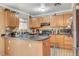 Kitchen featuring wooden cabinets, black countertops, and stainless steel appliances at 5900 Fawn Ave, Las Vegas, NV 89107