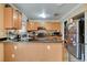 A kitchen featuring wood cabinets, granite countertops, and stainless steel appliances at 5900 Fawn Ave, Las Vegas, NV 89107