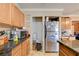 Kitchen area with stainless steel fridge and wooden cabinetry at 5900 Fawn Ave, Las Vegas, NV 89107
