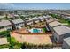 Aerial view of a vacant lot in a community, with a home with a pool next door at 5947 Wellington Peak Rd, Las Vegas, NV 89148