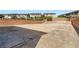A leveled vacant backyard, surrounded by a brick wall, ready for customization and landscaping at 5947 Wellington Peak Rd, Las Vegas, NV 89148