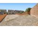 A leveled and vacant backyard enclosed by a brick wall, ready to build your custom dream backyard at 5947 Wellington Peak Rd, Las Vegas, NV 89148